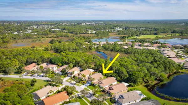 an aerial view of a houses with a yard