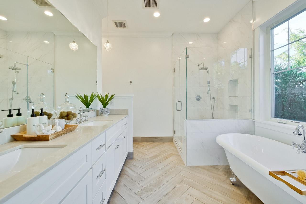 10326 Prune Tree Lane Cupertino, CA 95014 - Photo 13 of 95 a bathroom with a double vanity sink a large mirror and a bathtub