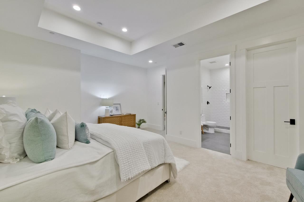 10326 Prune Tree Lane Cupertino, CA 95014 - Photo 16 of 95 a spacious bedroom with a bed and a couch