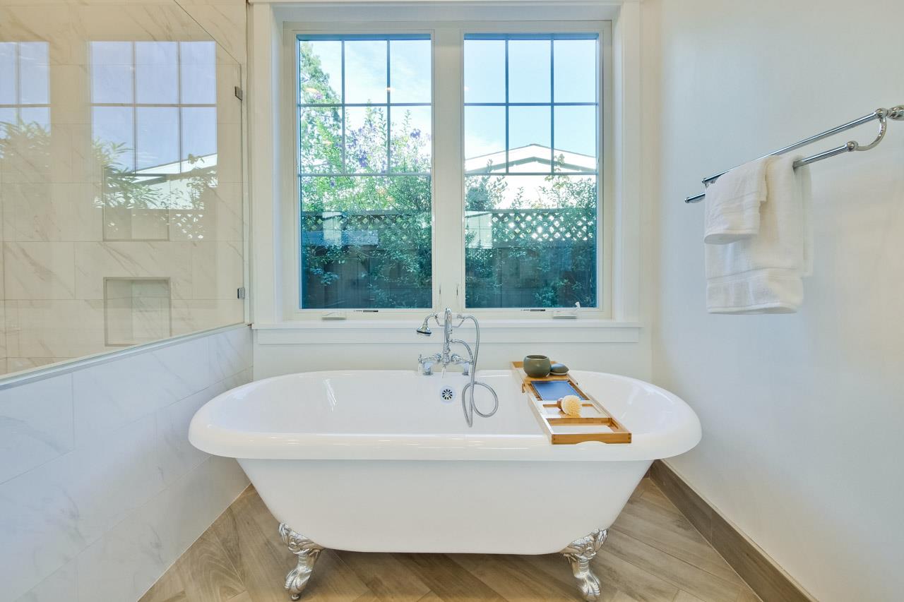 10326 Prune Tree Lane Cupertino, CA 95014 - Photo 19 of 95 a white bath tub sitting in a bathroom next to a window