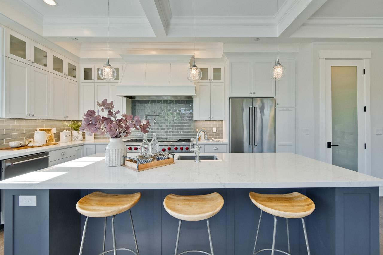 10326 Prune Tree Lane Cupertino, CA 95014 - Photo 32 of 95 a kitchen with stainless steel appliances granite countertop a dining table chairs and a refrigerator