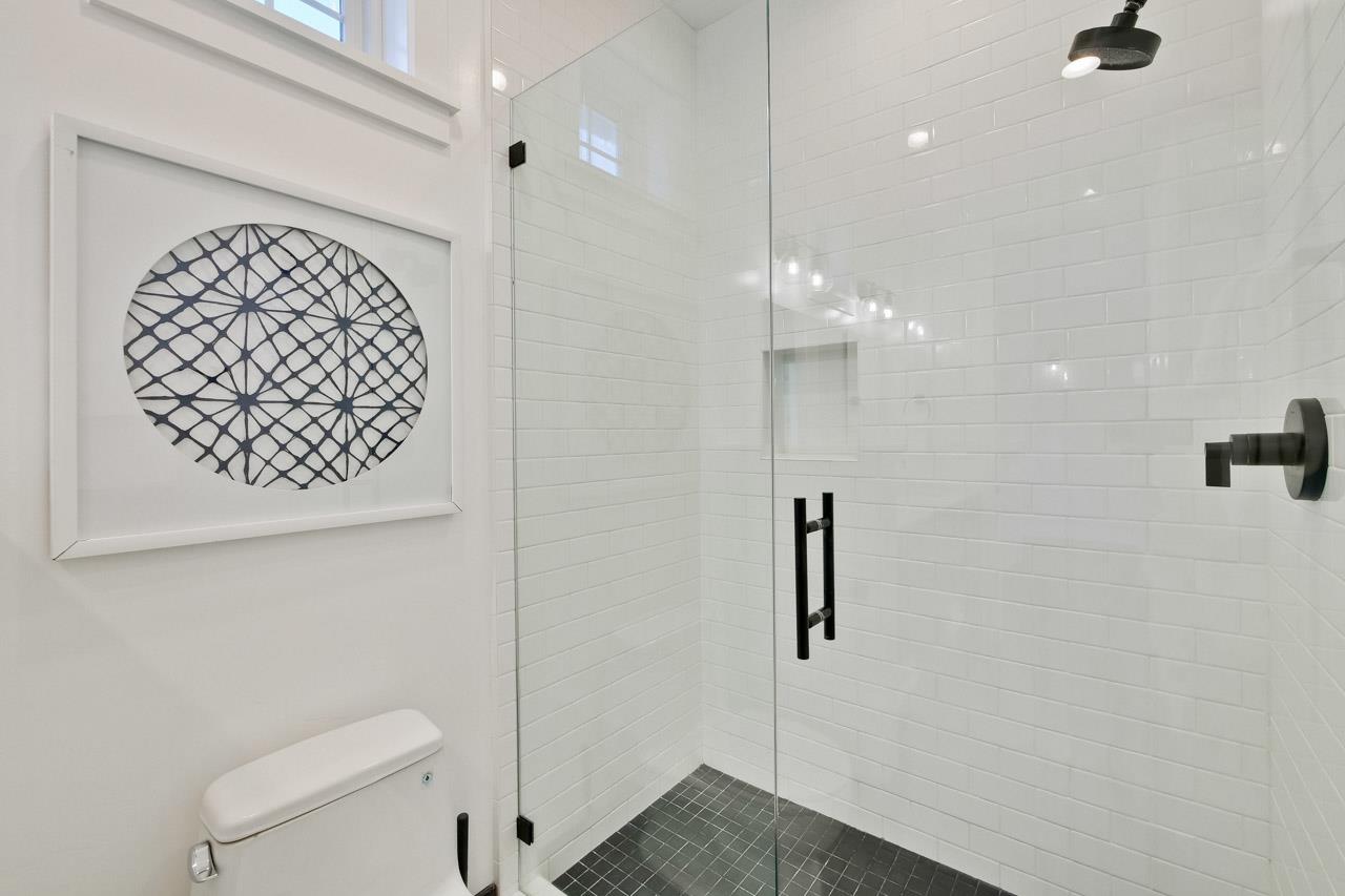 10326 Prune Tree Lane Cupertino, CA 95014 - Photo 70 of 95 a bathroom with a shower a toilet a sink and mirror