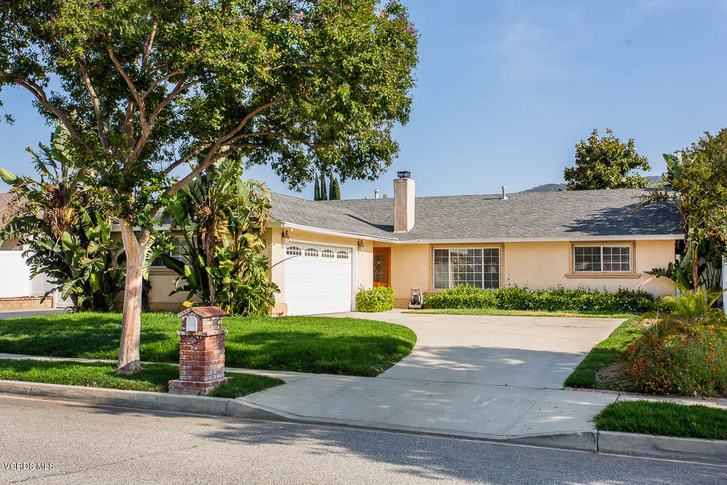 2460 Fitzgerald Road Simi Valley, CA 93065 - Photo 1 of 35 a front view of a house with a yard and potted plants
