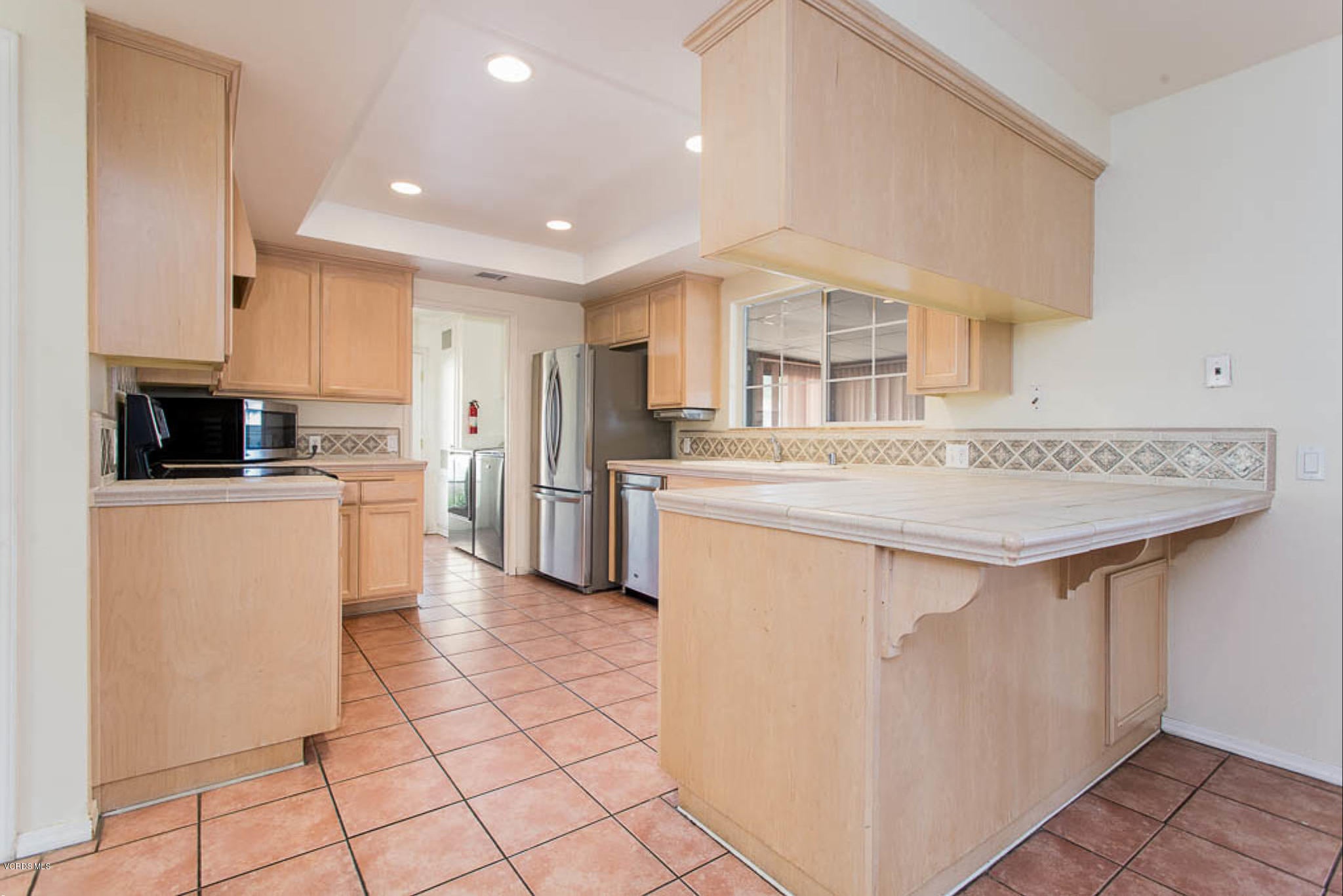 2460 Fitzgerald Road Simi Valley, CA 93065 - Photo 14 of 35 a kitchen with stainless steel appliances granite countertop a stove a sink and a refrigerator