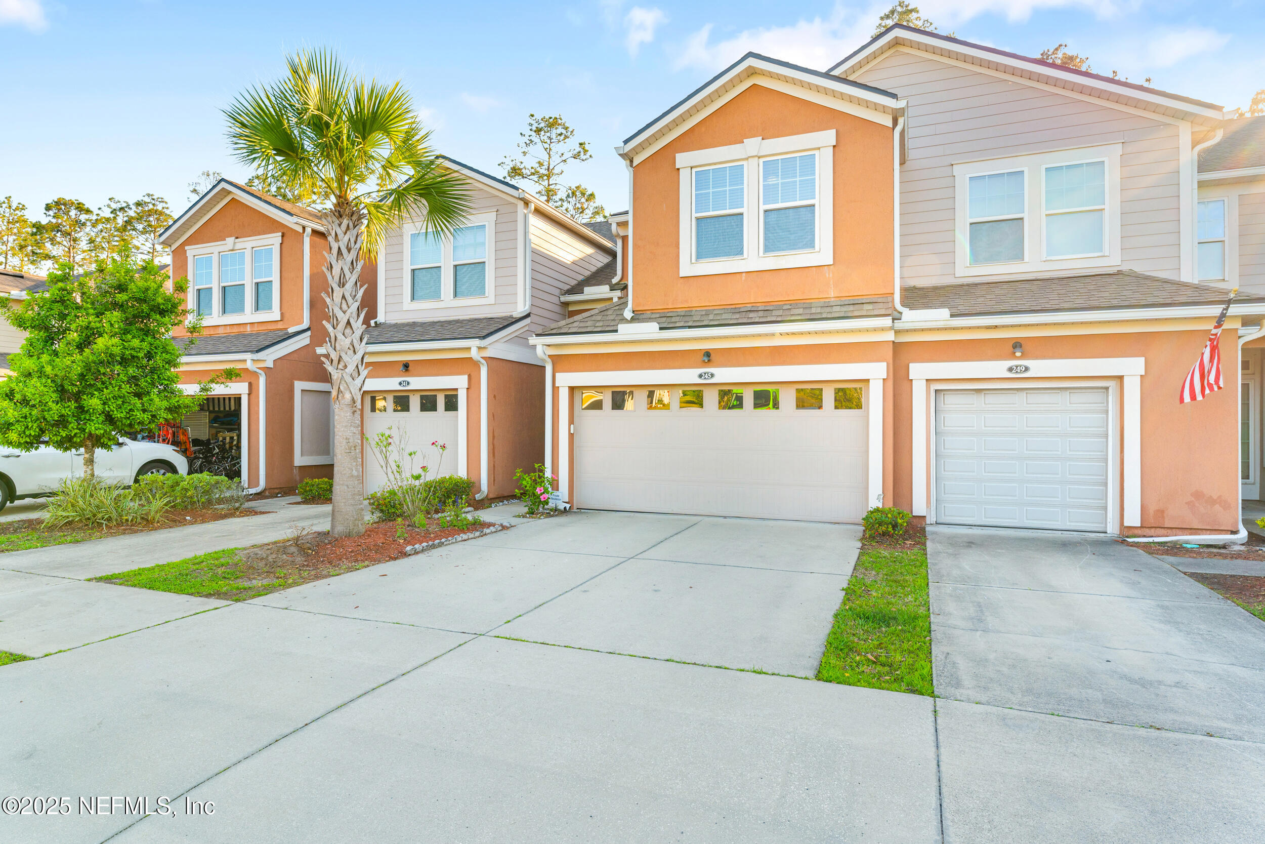 245 Richmond Drive St. Johns, FL 32259 - Photo 1 of 18 a front view of a house with a yard and garage