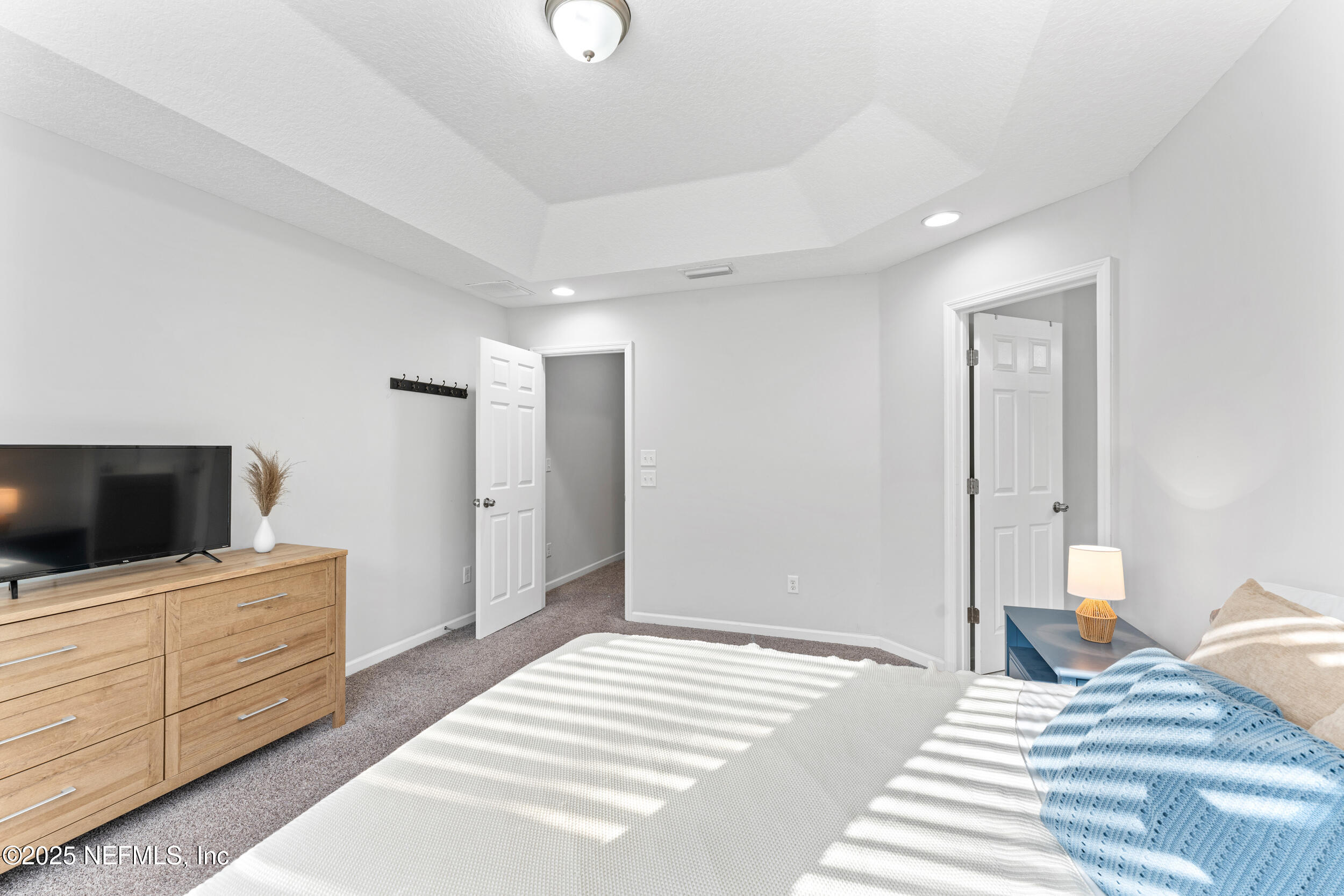 245 Richmond Drive St. Johns, FL 32259 - Photo 11 of 18 a bedroom with a bed and a flat screen tv