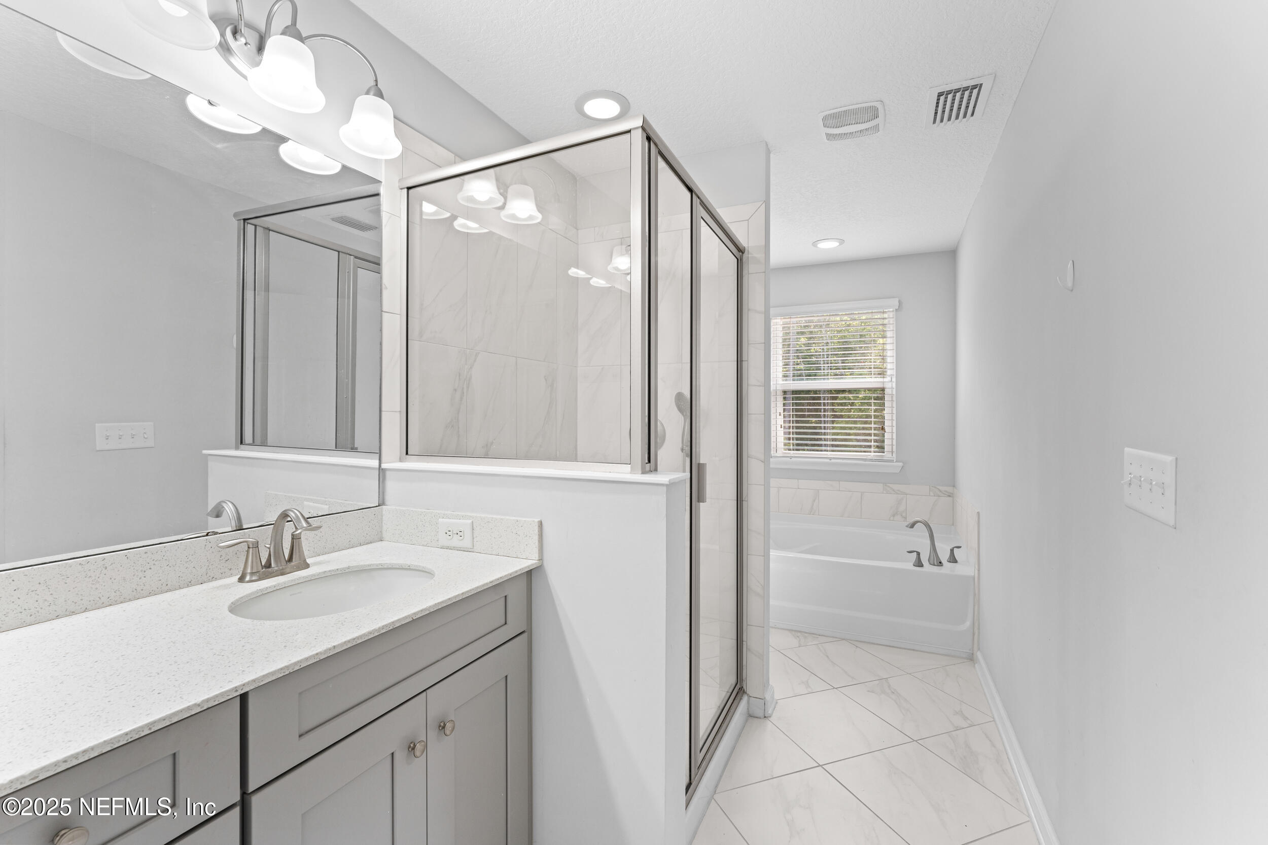 245 Richmond Drive St. Johns, FL 32259 - Photo 12 of 18 a bathroom with a shower sink vanity and mirror