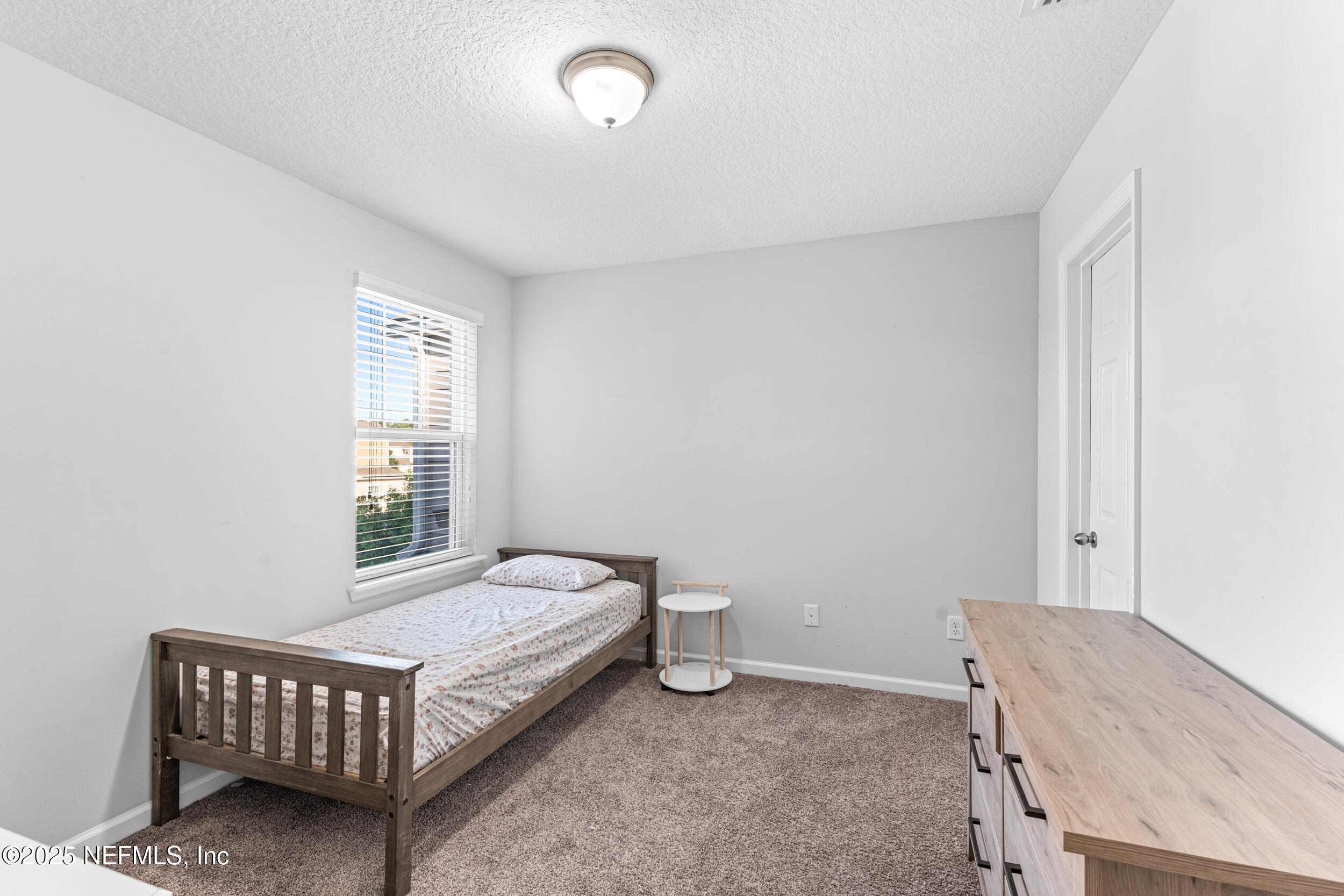 245 Richmond Drive St. Johns, FL 32259 - Photo 16 of 18 a bed room with a bed and a window