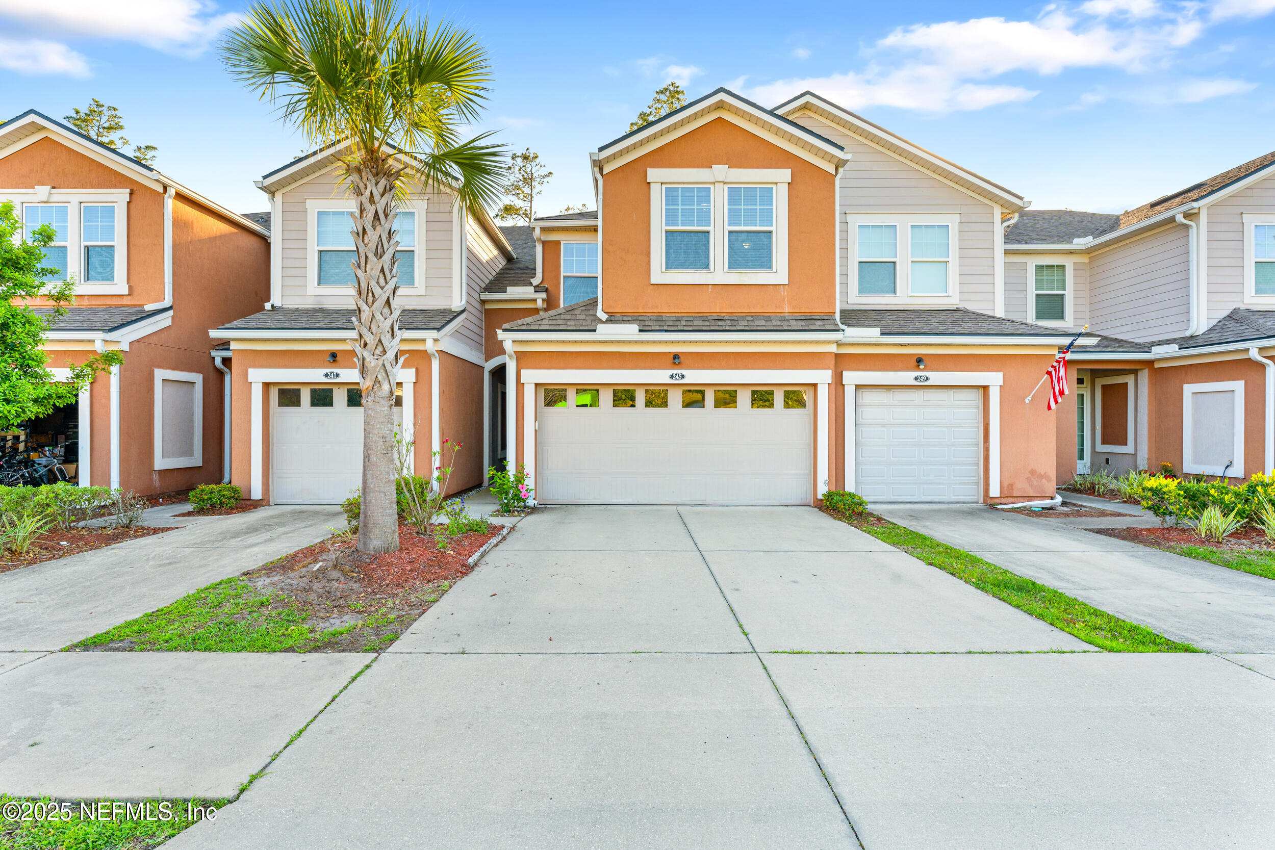 245 Richmond Drive St. Johns, FL 32259 - Photo 2 of 18 a front view of a house with a yard and garage