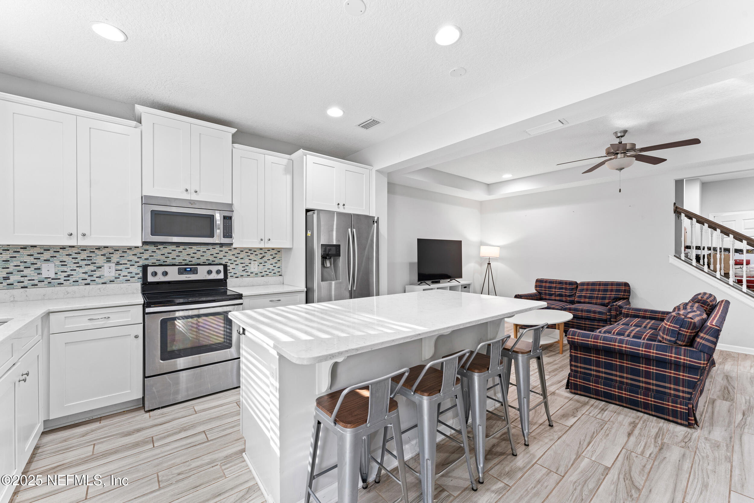 245 Richmond Drive St. Johns, FL 32259 - Photo 6 of 18 a kitchen with stainless steel appliances a stove a sink dishwasher a refrigerator with a dining table and chairs