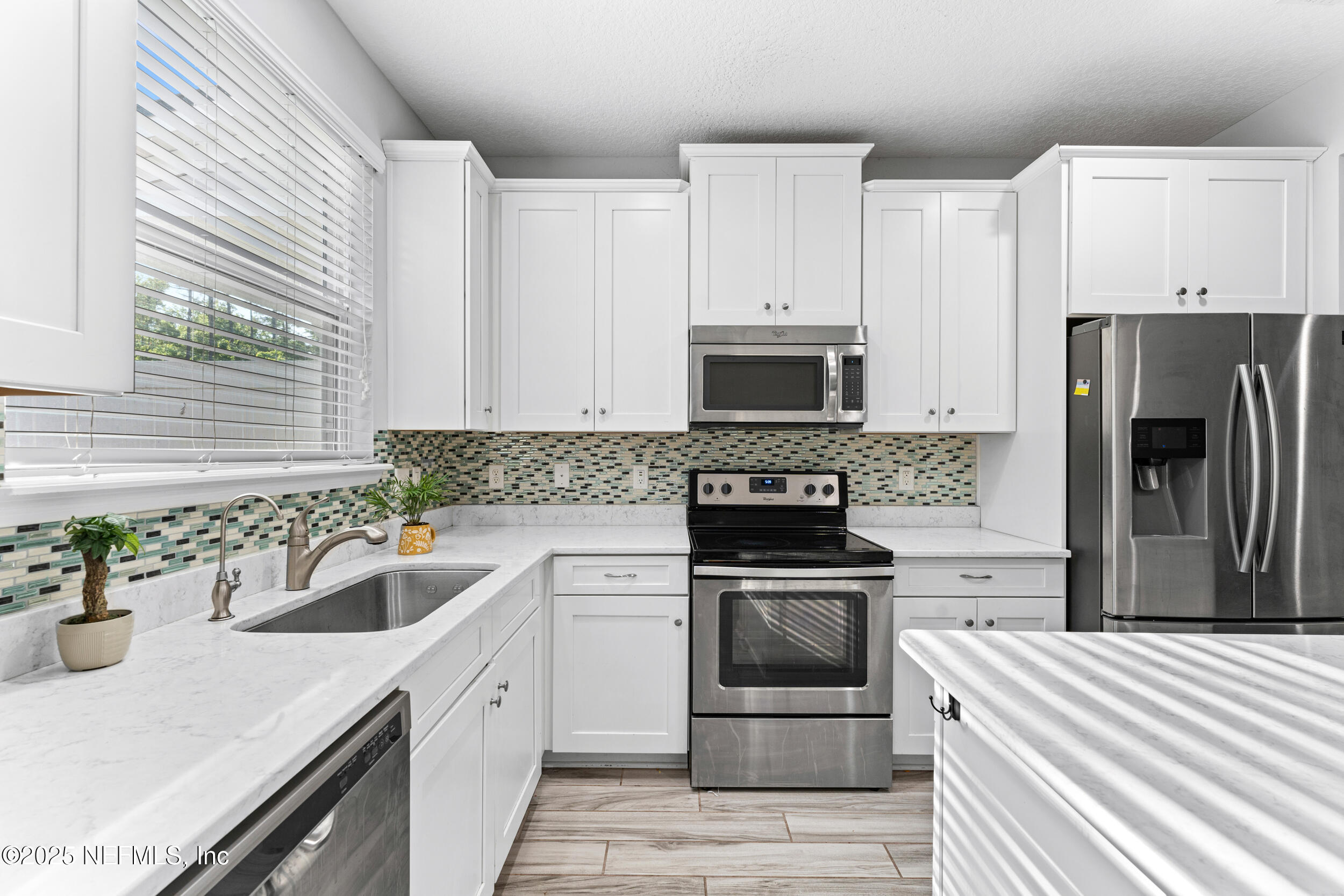 245 Richmond Drive St. Johns, FL 32259 - Photo 7 of 18 a kitchen with white cabinets and stainless steel appliances