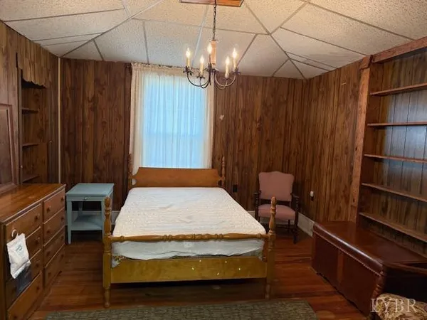 a spacious bedroom with a bed and a chandelier