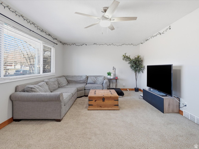 322 East 900 North Logan, UT 84321 - Photo 6 of 43 Living area featuring a ceiling fan and light colored carpet