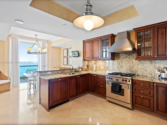 a kitchen with stainless steel appliances granite countertop a stove and a sink