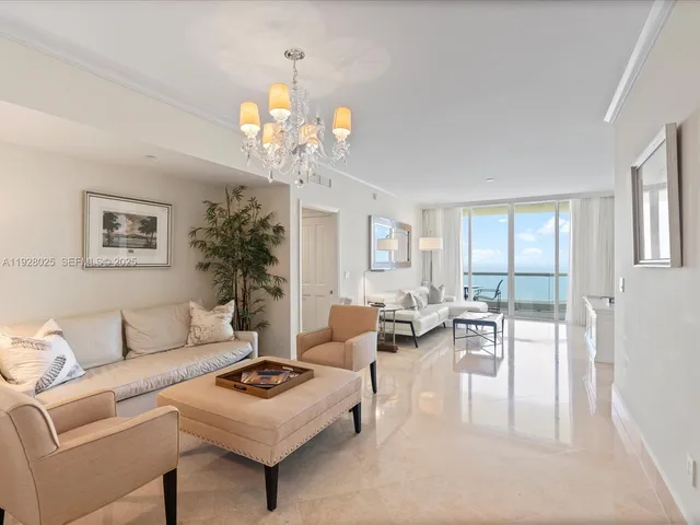 a living room with furniture a chandelier a rug and a window