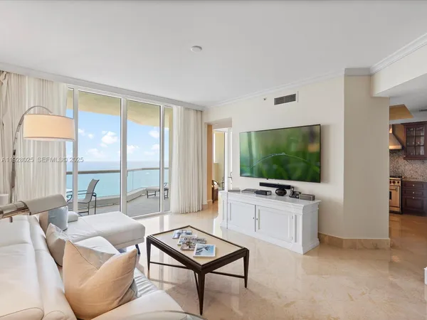 a living room with furniture a flat screen tv and a large window