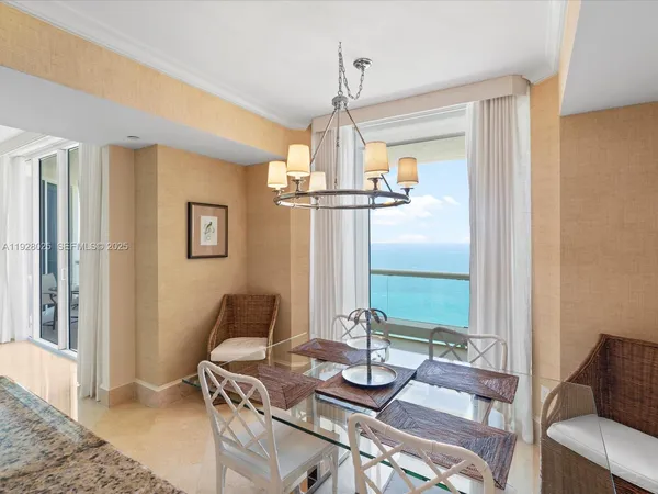 a dining room with furniture and a chandelier