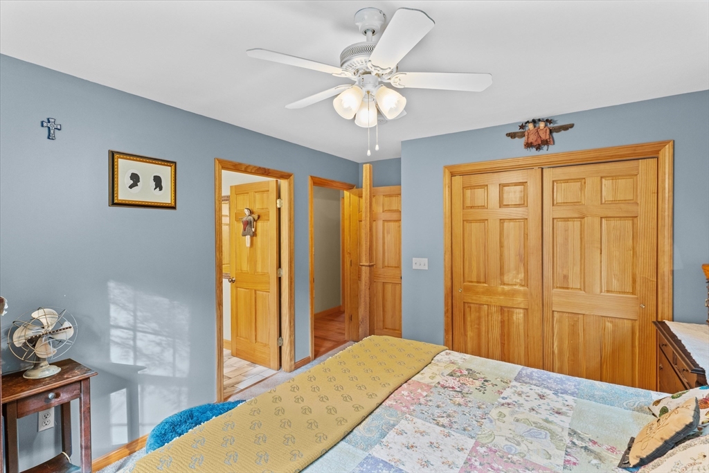 4109 South Athol Road Athol, MA 01331 - Photo 11 of 38 a bedroom with a bed and a chandelier