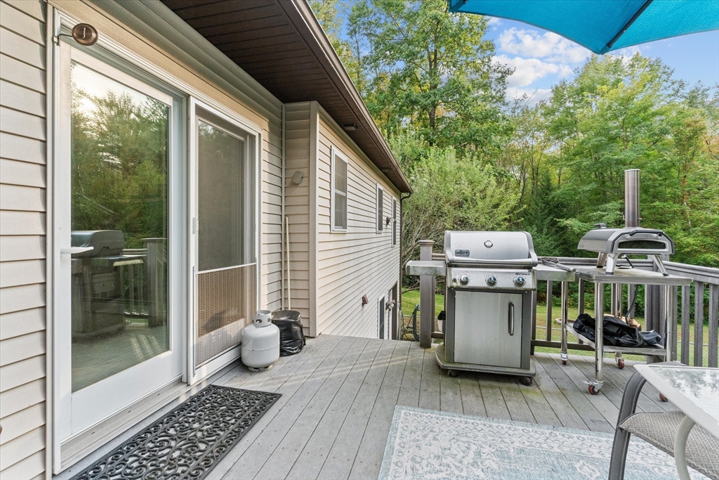 4109 South Athol Road Athol, MA 01331 - Photo 24 of 38 a view of a patio with table and chairs with wooden floor and fence