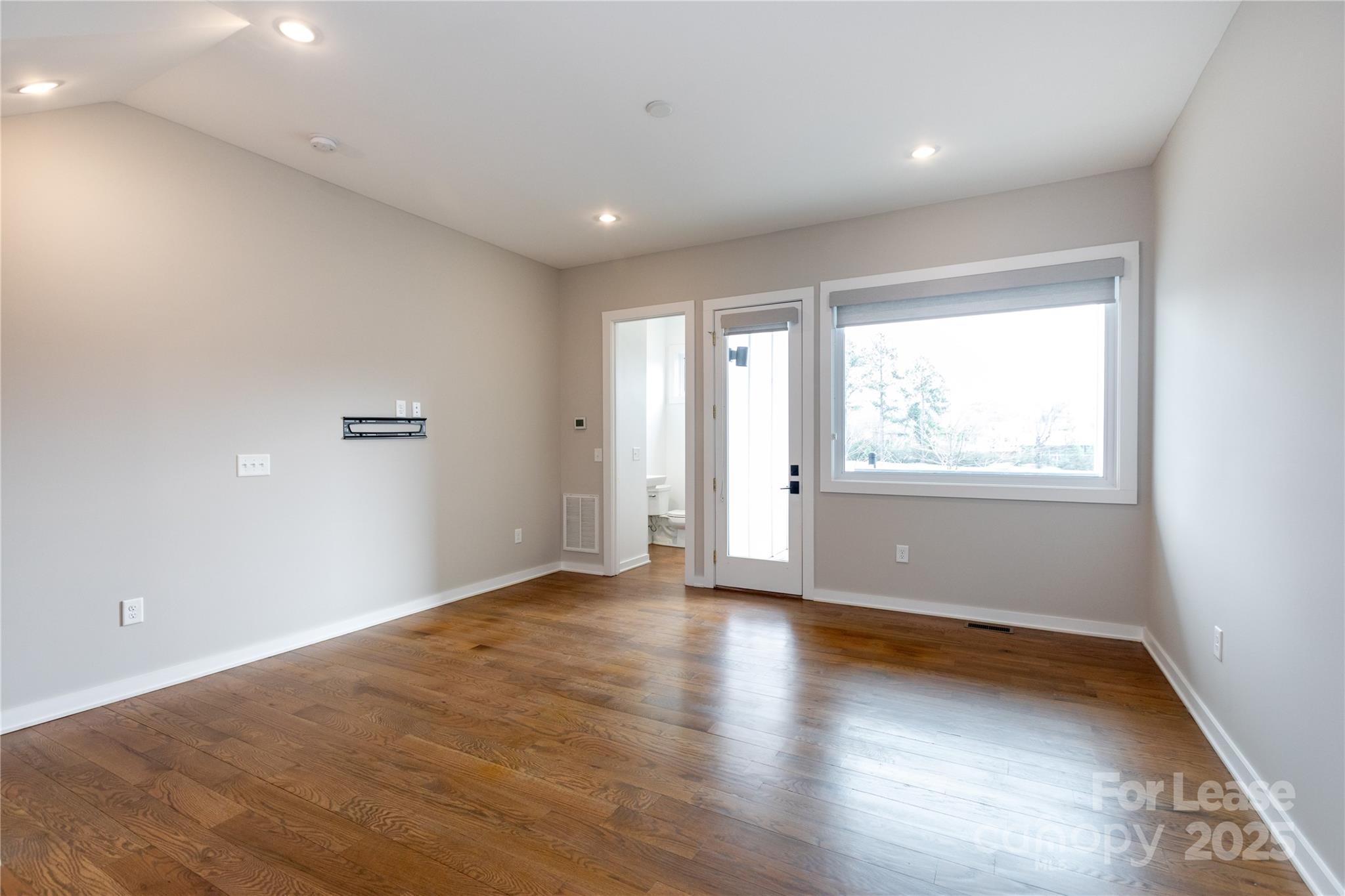 2649 Shenandoah Avenue Charlotte, NC 28205 - Photo 30 of 37 an empty room with wooden floor and windows