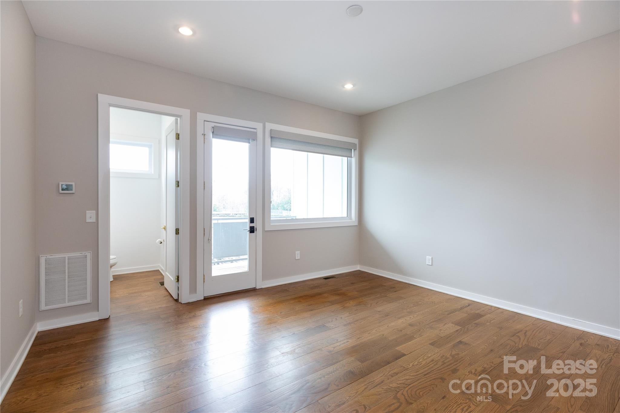 2649 Shenandoah Avenue Charlotte, NC 28205 - Photo 4 of 37 an empty room with wooden floor and windows
