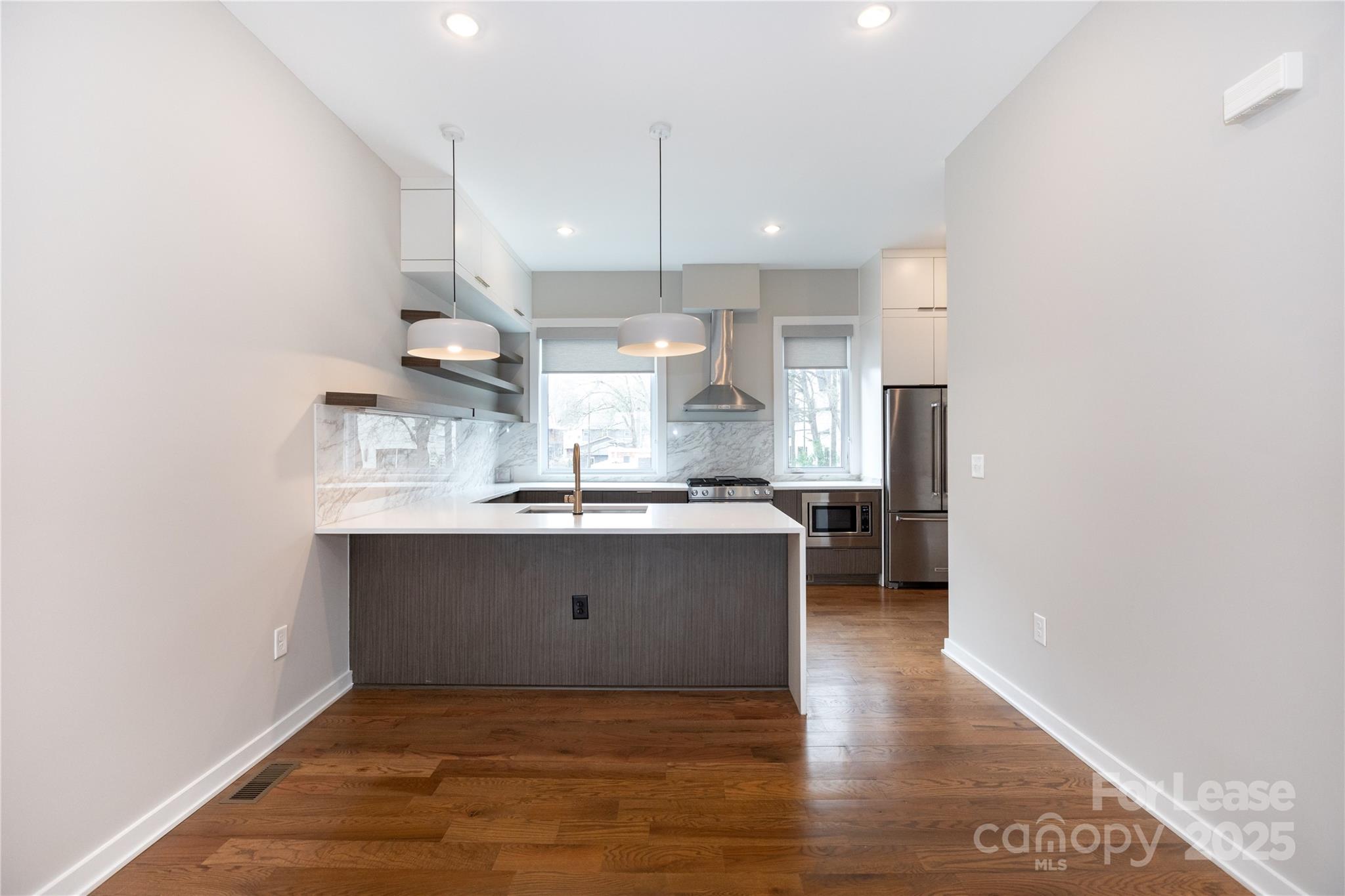 2649 Shenandoah Avenue Charlotte, NC 28205 - Photo 6 of 37 a kitchen with kitchen island a sink appliances and a counter top space