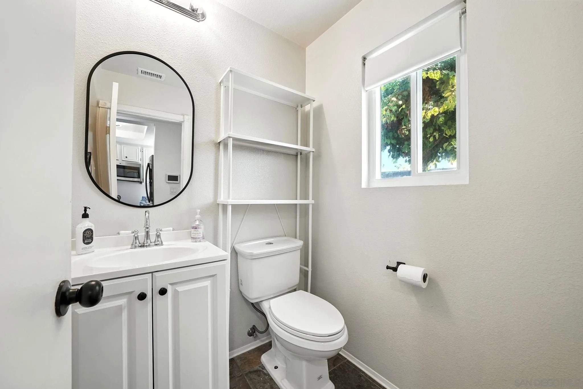 2256 Kings View Circle Spring Valley, CA 91977 - Photo 12 of 35 a bathroom with a toilet sink and mirror