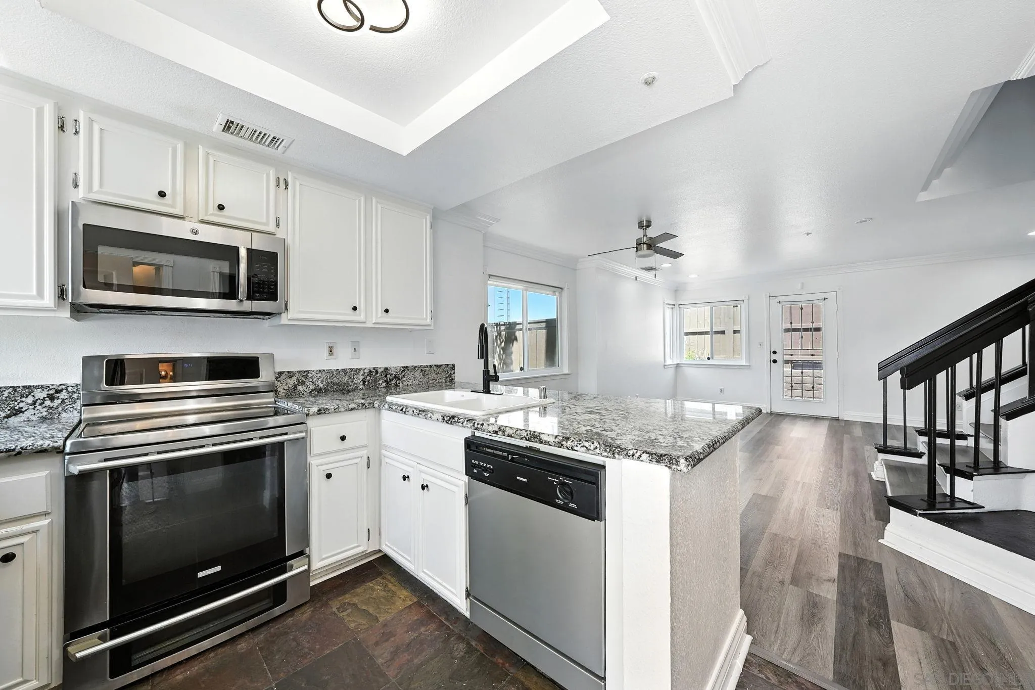 2256 Kings View Circle Spring Valley, CA 91977 - Photo 3 of 35 a kitchen with granite countertop a stove top oven and cabinets