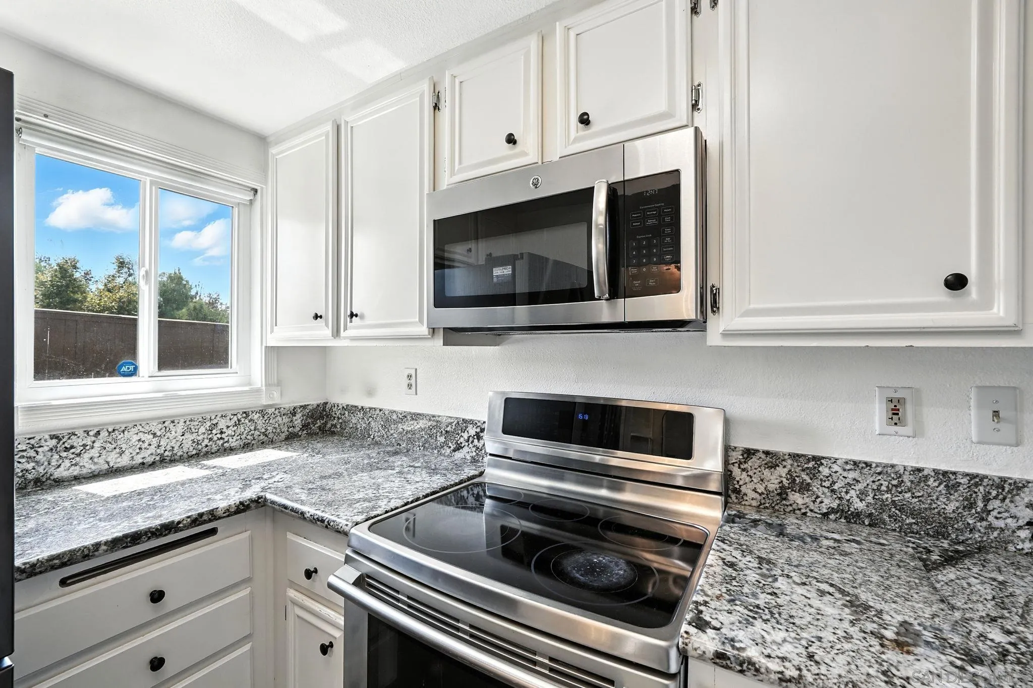 2256 Kings View Circle Spring Valley, CA 91977 - Photo 4 of 35 a kitchen with appliances a sink and cabinets