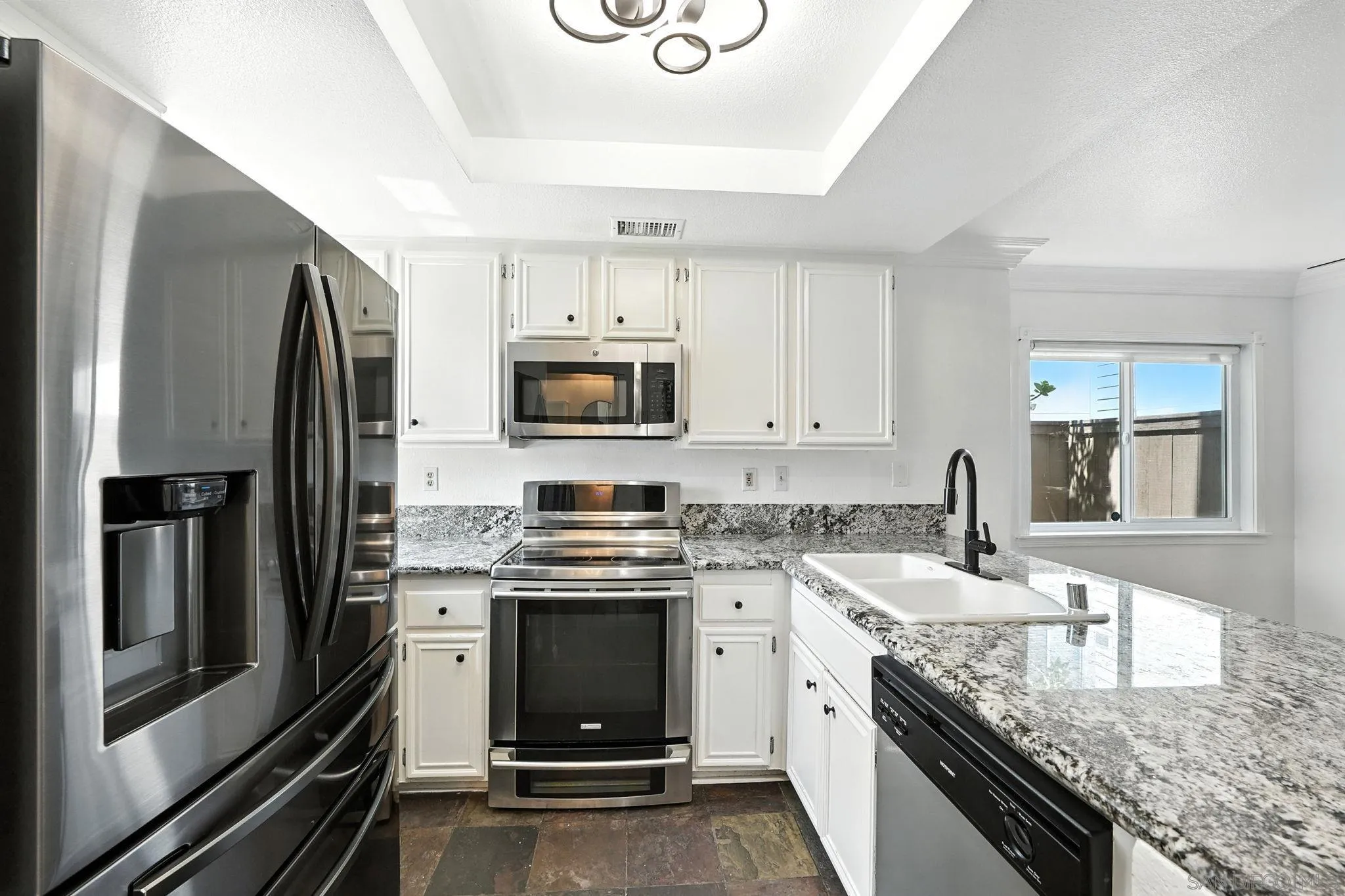 2256 Kings View Circle Spring Valley, CA 91977 - Photo 7 of 35 a kitchen with a sink stove and refrigerator