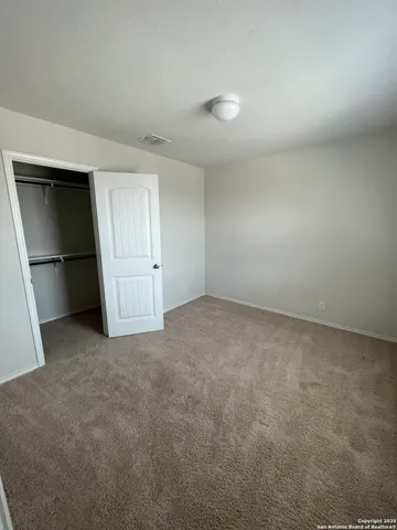 an empty room with closet and garage