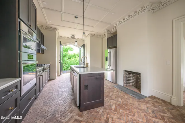a kitchen with a refrigerator and a sink