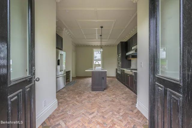 a view of a hallway with wooden shelves