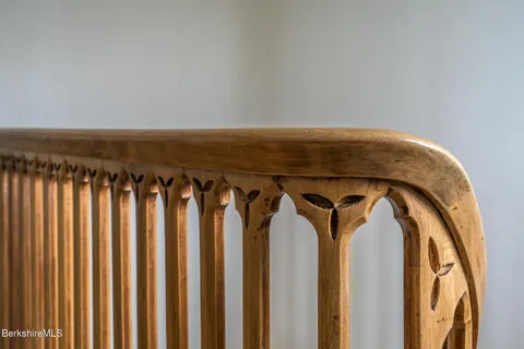 a bedroom with a bed and large windows