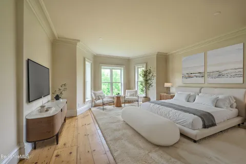 a view of a hallway to a livingroom with furniture