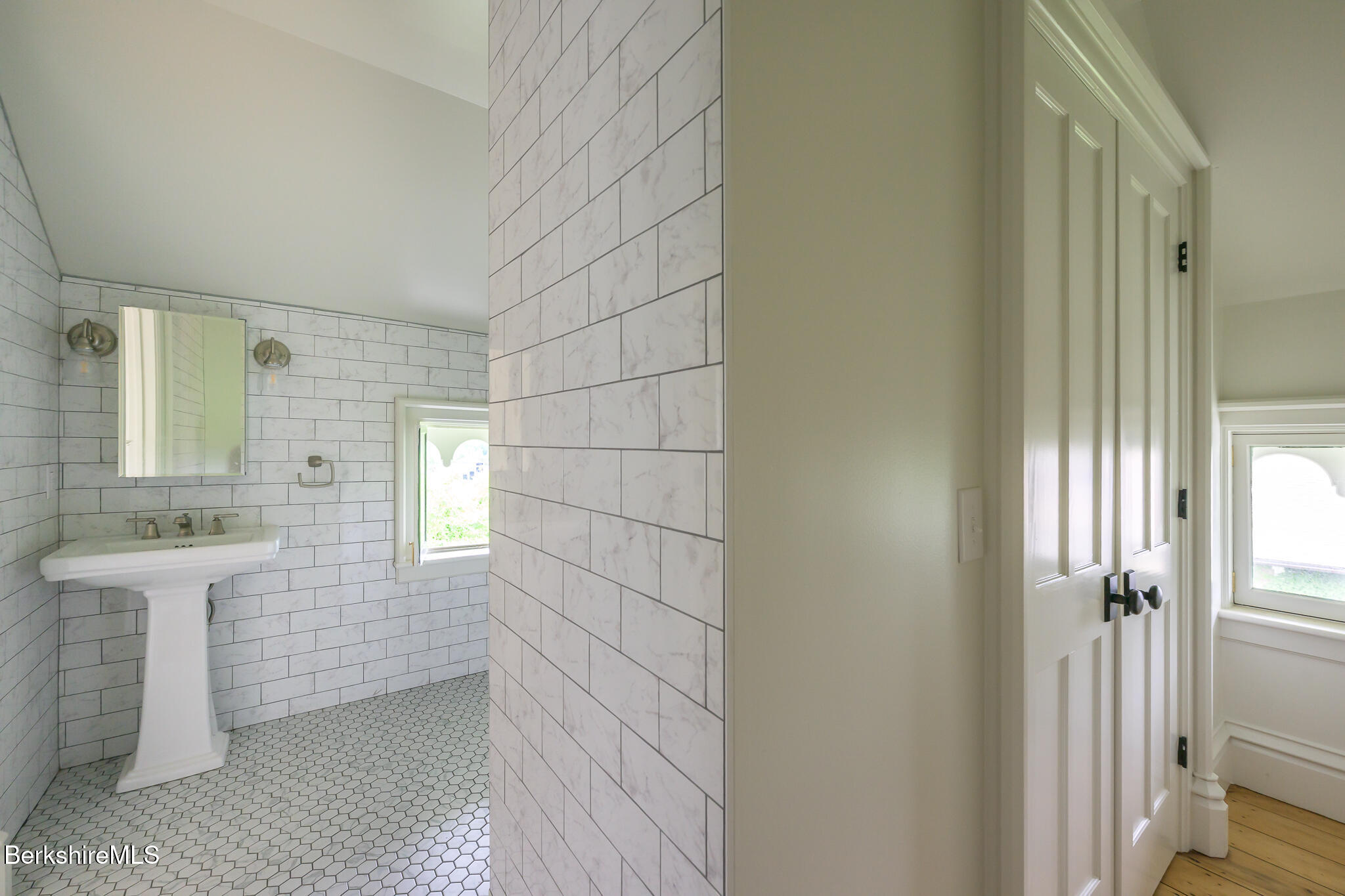 59 Allen Street Hudson, NY 12534 - Photo 46 of 59 a bathroom with a sink a mirror and a shower
