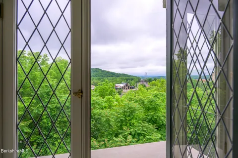 an aerial view of a house with a yard and garden