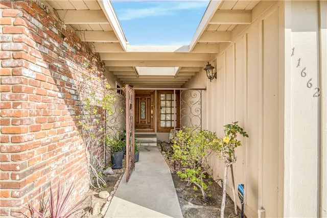 a front view of a house with a potted plant