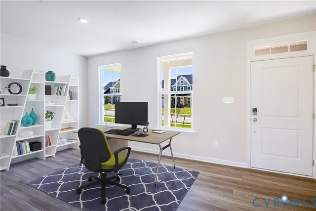 a view of a workspace with furniture and a window