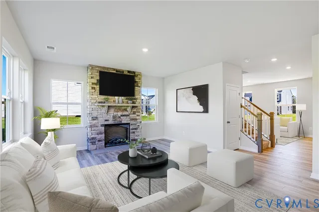 a living room with furniture a fireplace and a flat screen tv
