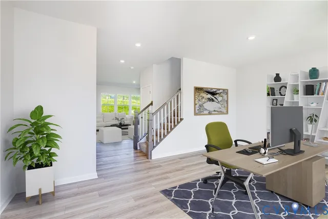 a living room with furniture and wooden floor