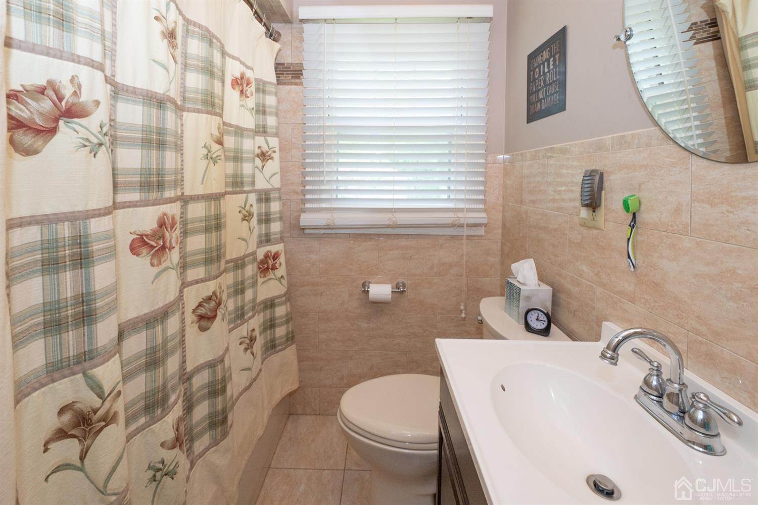 189 Texas Road Old Bridge, NJ 08857 - Photo 20 of 35 a bathroom with a sink a toilet and shower curtain