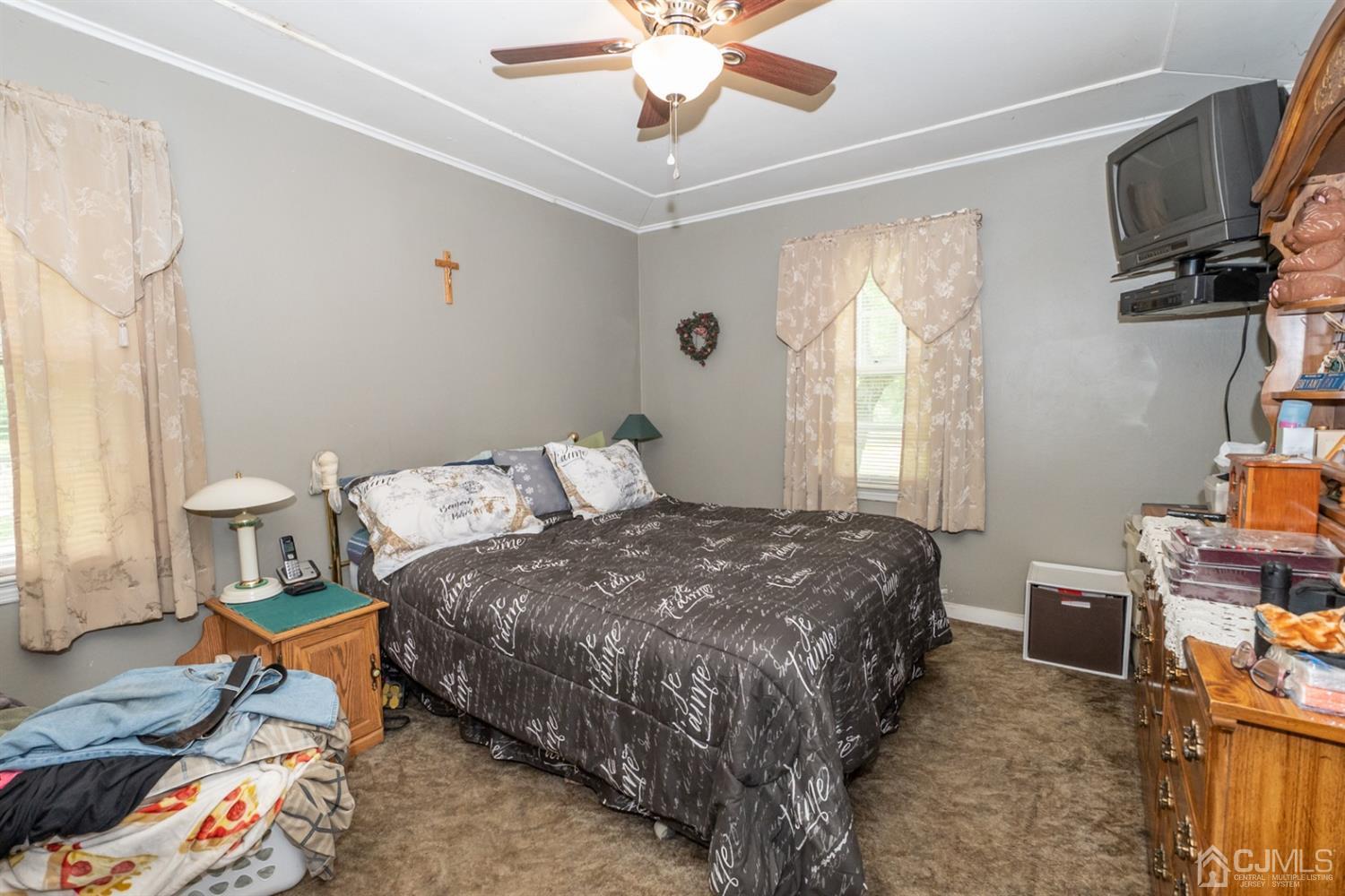 189 Texas Road Old Bridge, NJ 08857 - Photo 22 of 35 a bedroom with a bed a flat screen tv and a window