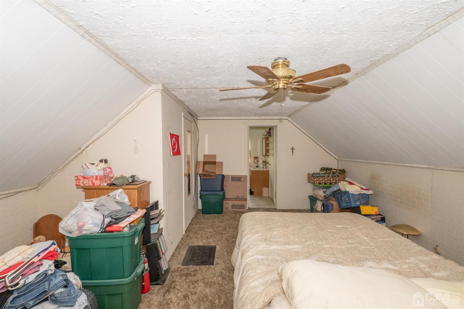 189 Texas Road Old Bridge, NJ 08857 - Photo 27 of 35 a bedroom with a bed and a chandelier