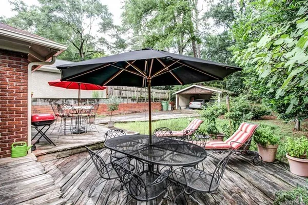a view of a chairs and table in the patio