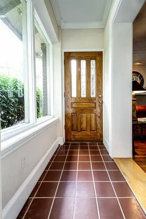 a view of an empty room with a window and a fireplace