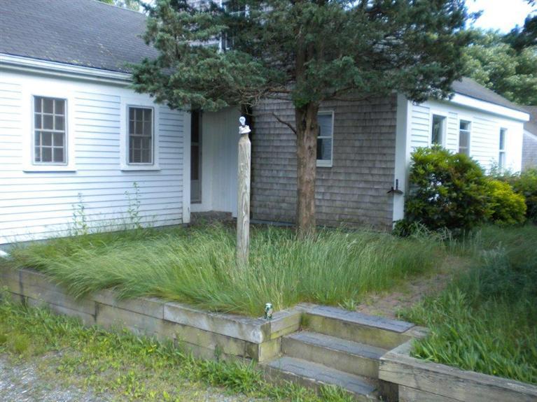 52 Telegraph Road Dennis Port, MA 02639 - Photo 1 of 13 a backyard of a house with plants and entertaining space