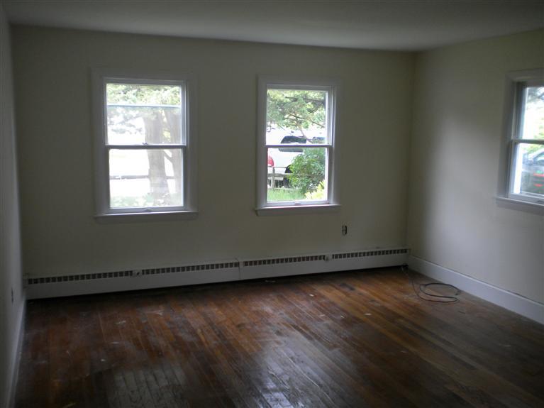 52 Telegraph Road Dennis Port, MA 02639 - Photo 4 of 13 an empty room with wooden floor and windows