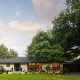 a view of an house with backyard space and garden