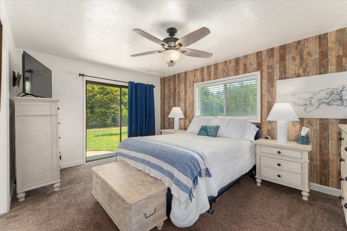 12325 Craig Avenue Red Bluff, CA 96080 - Photo 23 of 68 a spacious bedroom with a bed a window and a couch